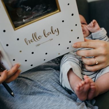 Pearhead&reg; "Hello Baby" Sonogram Baby Memory Book, Black and Gold Polka Dots. View a larger version of this product image.