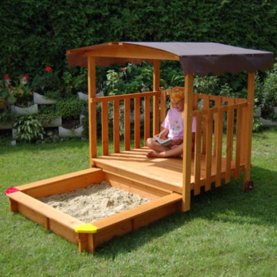 outdoor playhouse with sandbox