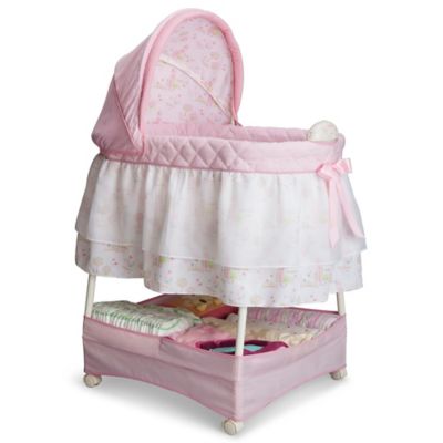 pink and white bassinet