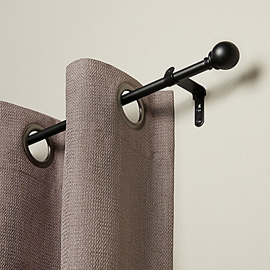 Umbra&reg; Cafe 18 to 28-Inch Adjustable Curtain Rod in Black. View a larger version of this product image.