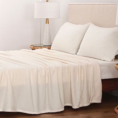 Bee &amp; Willow&trade; Solid Plush Full/Queen Blanket in Cream. View a larger version of this product image.