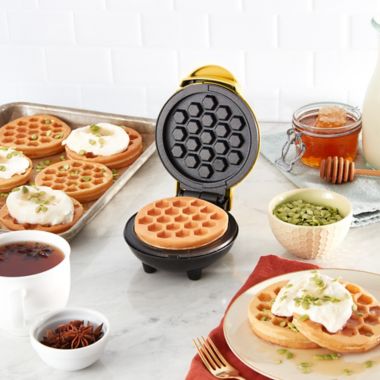 Dash&reg; Honeycomb Mini Waffle Maker in Yellow. View a larger version of this product image.