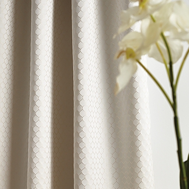 Martha Stewart Lynx 84-Inch Grommet 100% Blackout Window Curtain Panels in Ivory (Set of 2). View a larger version of this product image.