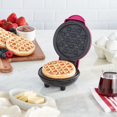 Dash&reg; Love Mini Waffle Maker in Magenta. View a larger version of this product image.