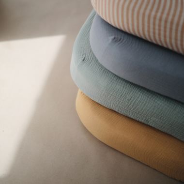 Mushie&reg; Muslin Fitted Crib Sheet in Natural. View a larger version of this product image.
