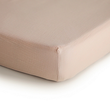 Mushie&reg; Muslin Fitted Crib Sheet in Blush. View a larger version of this product image.