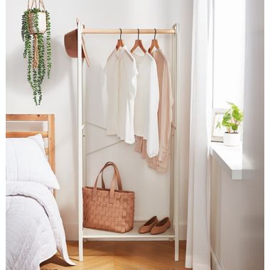 Squared Away&trade; Metal Garment Rack with Storage Base in Coconut Milk. View a larger version of this product image.