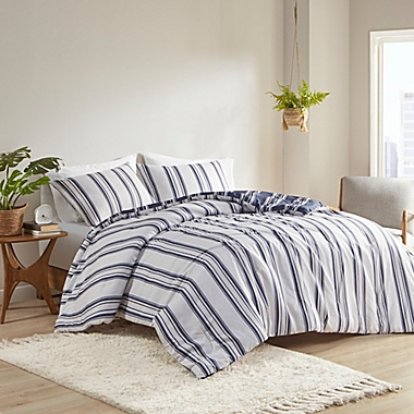 Clean Spaces Cobi 3-Piece Reversible Striped Full/Queen Comforter Set in Navy. View a larger version of this product image.