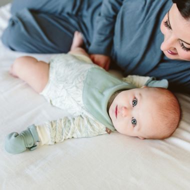 goumi 0-12M 2-Pack Reversible Organic Cotton Bibs in Green/Grey. View a larger version of this product image.