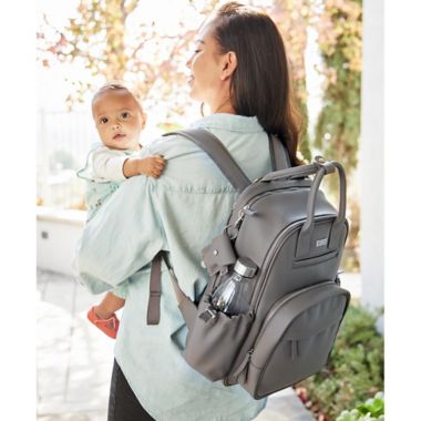 JuJuBe&reg; Million Pockets Faux Leather Deluxe Diaper Backpack in Earth Leather. View a larger version of this product image.