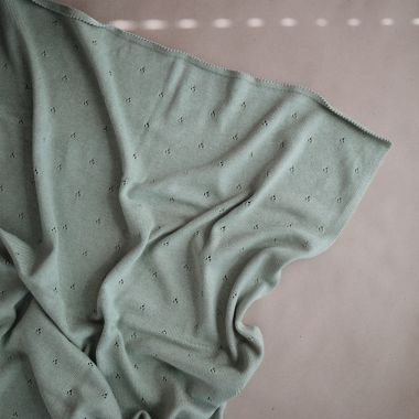 Mushie Knitted Pointelle Baby Blanket in Sage M&eacute;lange. View a larger version of this product image.