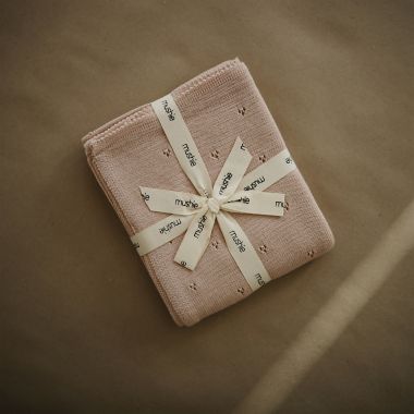 Mushie Knitted Textured Dots Baby Blanket in Blush. View a larger version of this product image.