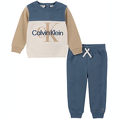 Calvin Klein&reg; Size 6-9M 2-Piece CK Logo Sweatshirt and Jogger Set in Ivory/Blue. View a larger version of this product image.