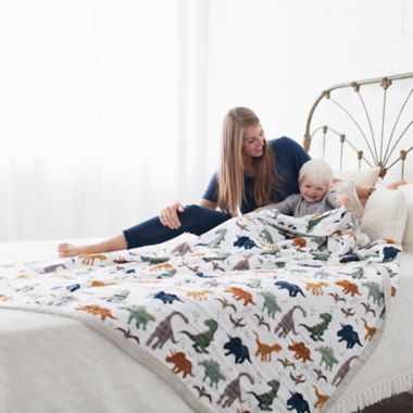 Little Unicorn Dino Friends Cotton Muslin Quilted Throw. View a larger version of this product image.