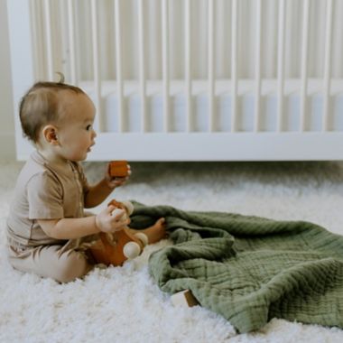 Little Unicorn&reg; Fern Cotton Muslin Baby Receiving Quilt in Green. View a larger version of this product image.