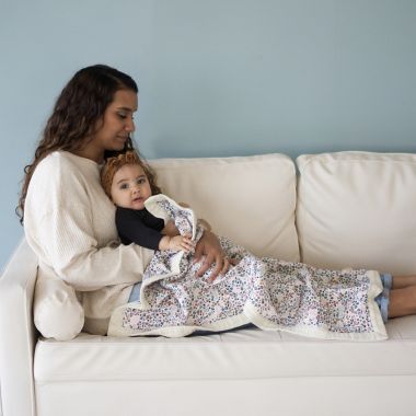 Little Unicorn&reg; Pressed Petals Cotton Muslin Baby Receiving Quilt in Pink. View a larger version of this product image.