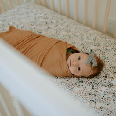 Little Unicorn&reg; Cotton Muslin Fitted Sheet in Pressed Petals. View a larger version of this product image.