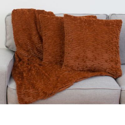 orange throw blanket and pillows