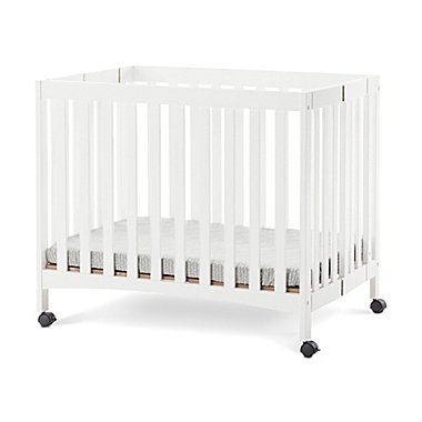 Forever Eclectic by Child Craft London Folding Mini Crib in Matte White. View a larger version of this product image.