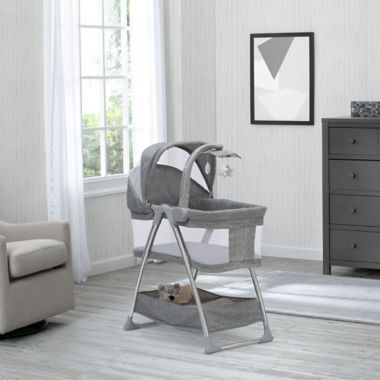 Simmons Kids City Sleeper Trendy Bassinet in Grey with Electronic Mobile by Delta Children. View a larger version of this product image.
