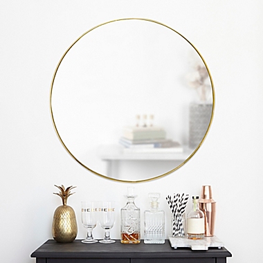Umbra&reg; Hubba 34-Inch Round Wall Mirror in Brass. View a larger version of this product image.