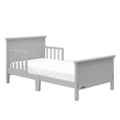 white wooden toddler bed