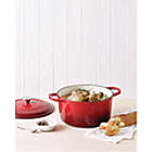 Alternate image 4 for Our Table&trade; 6 qt. Enameled Cast Iron Dutch Oven with Stainless Steel Knob in Red