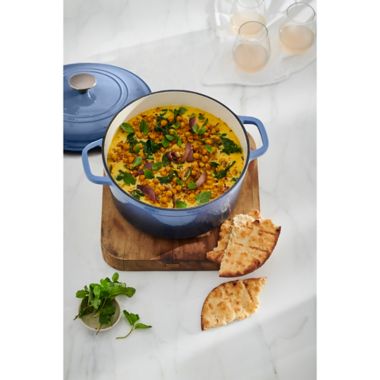 Our Table&trade; 6 qt. Enameled Cast Iron Dutch Oven with Stainless Steel Knob in Denim. View a larger version of this product image.