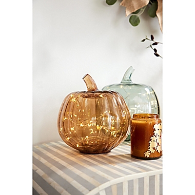 Bee &amp; Willow&trade; Glass LED-Lit Pumpkin Decoration in Amber. View a larger version of this product image.