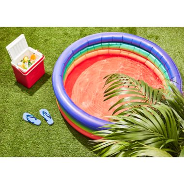 Pool Candy Adult Inflatable Rainbow Sunning Pool. View a larger version of this product image.