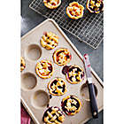 Alternate image 1 for Our Table&trade; 12-Cup Textured Muffin Pan in Beige