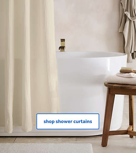 Bathroom scene featuring Haven shower curtains, Haven towels, and a cotton robe from the Haven collection.