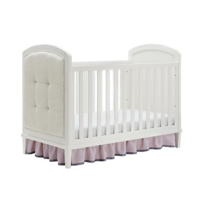 white upholstered crib