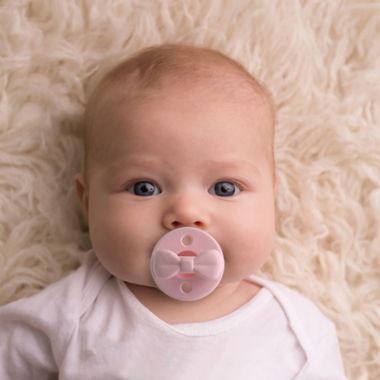 Itzy Ritzy&reg; Sweetie Soother&trade; 2-Pack Silicone Pacifier in Pink Bow. View a larger version of this product image.