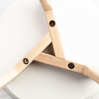 The Bianco Collection Cherie 15" Round Italian Carrara White Marble Side Table with Oak Legs. View a larger version of this product image.