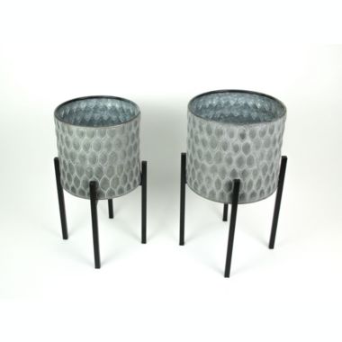 Napco Imports Set of 2 Galvanized Zinc Finish Leaf Pattern Stamped Metal Planters With Wooden Stands. View a larger version of this product image.