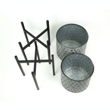 Napco Imports Set of 2 Galvanized Zinc Finish Leaf Pattern Stamped Metal Planters With Wooden Stands. View a larger version of this product image.